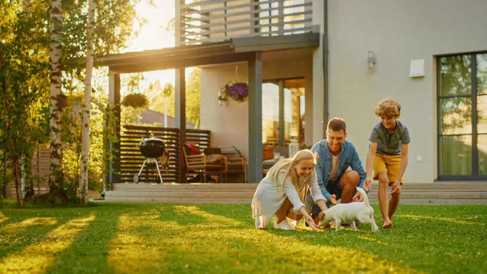 Happy family in the yard of their new house